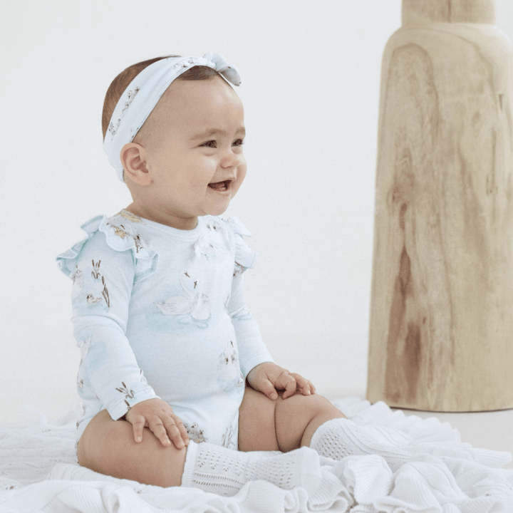 Cute-Smiling-Baby-Wearing-Aster-and-Oak-Organic-Cotton-Headband-Swan-Naked-Baby-Eco-Boutique