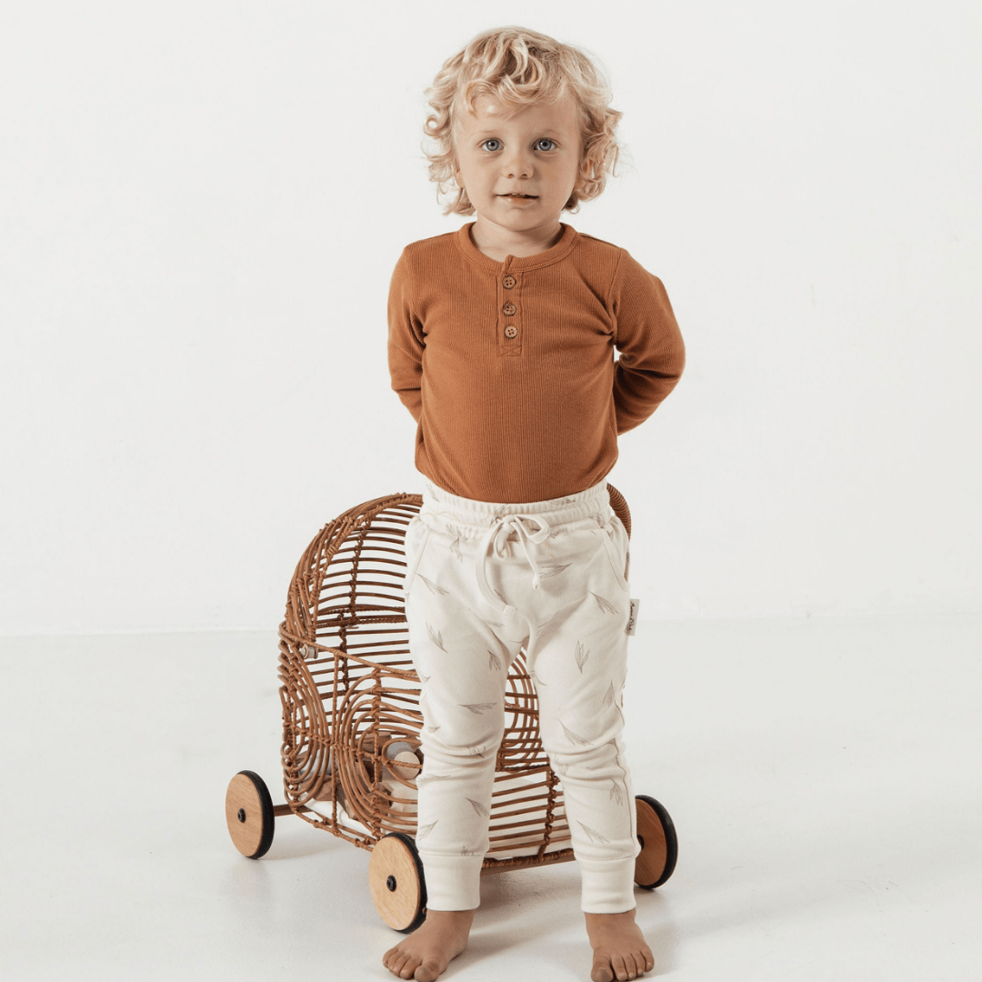 Cute-Toddler-Wearing-Aster-and-Oak-Organic-Rib-Onesie-Pecan-with-Harem-Pants-Naked-Baby-Eco-Boutique