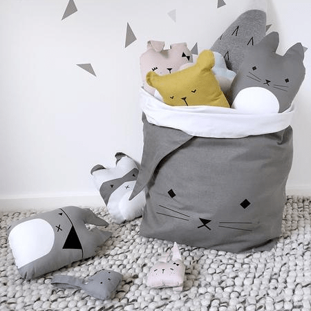 A grey bag with Fabelab Organic Cotton Animal Cushions - LUCKY LAST - BEAR (HONEY) in it.