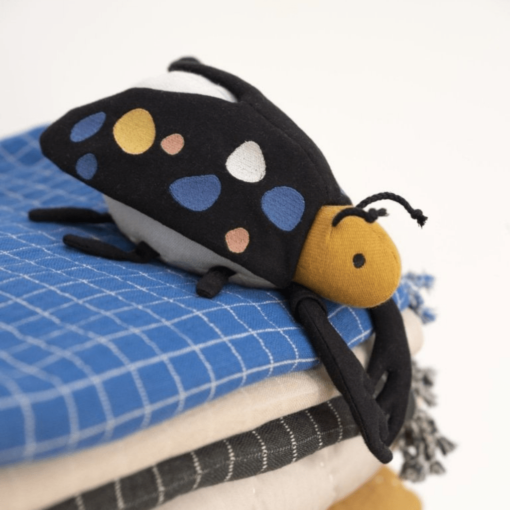 Fabelab-Organic-Cotton-Beetle-Rattle-on-Blanket-Stack-Naked-Baby-Eco-Boutique
