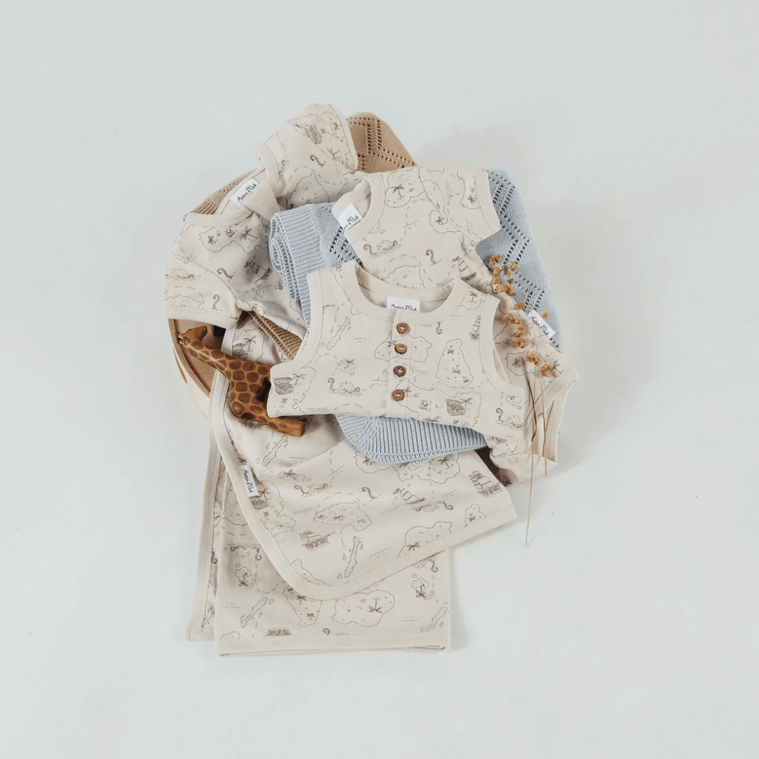 Flatlay-Of-Aster-And-Oak-Organic-Cotton-Pirate-Map-Henley-Romper-Naked-Baby-Eco-Boutique