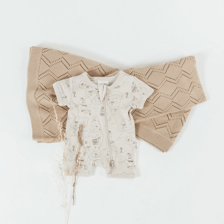 Flatlay-Of-Aster-And-Oak-Organic-Cotton-Zip-Romper-Pirate-Map-Naked-Baby-Eco-Boutique