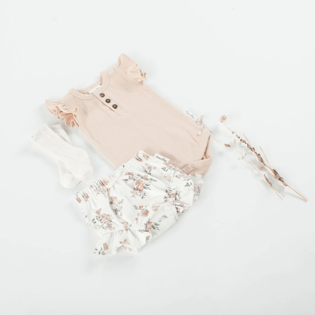 Flatlay-Of-Aster-And-Oak-Organic-Peach-Rib-Ruffle-Onesie-Naked-Baby-Eco-Boutique