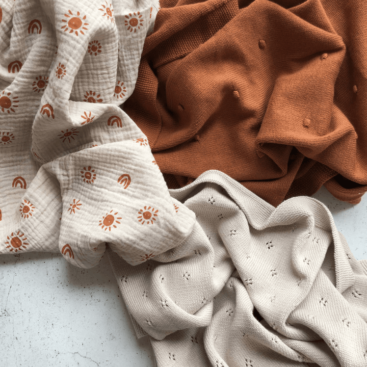 Flatlay-Of-Over-The-Dandelions-Organic-Cotton-Billie-Blanket-Burnt-Amber-Naked-Baby-Eco-Boutique