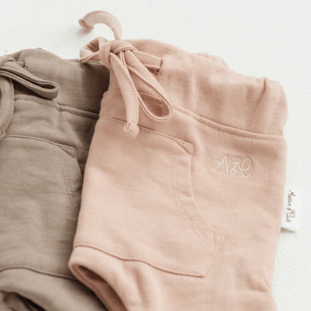 Flatlay-Showing-Both-Colours-Timber-And-Rose-Aster-And-Oak-Organic-Cotton-Jogger-Pants-Naked-Baby-Eco-Boutique