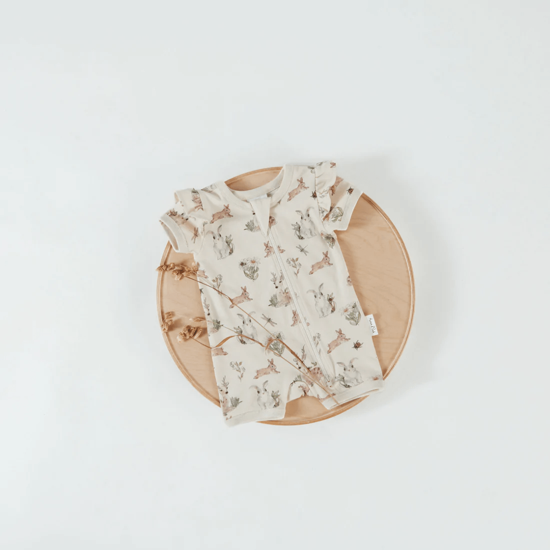 Flatlay-of-Aster-And-Oak-Organic-Cotton-Flutter-Sleeve-Zip-Romper-Prairie-Naked-Baby-Eco-Boutique