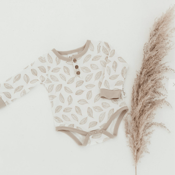 Flatlay-of-Aster-and-Oak-Organic-Cotton-AOP-Henley-Onesie-Leaf-Drop-Naked-Baby-Eco-Boutique