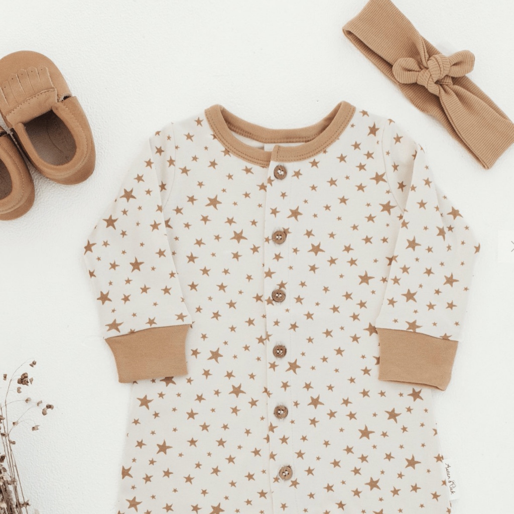 Flatlay-of-Aster-and-Oak-Organic-Cotton-Button-Romper-Taffy-Star-Naked-Baby-Eco-Boutique