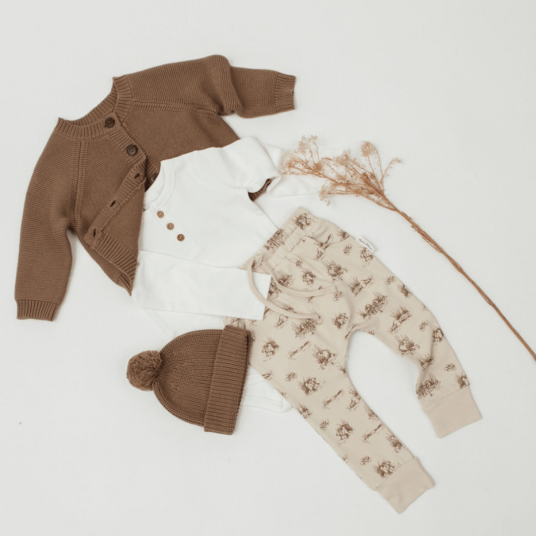 Flatlay-with-Little-Girl-Wearing-Aster-and-Oak-Organic-Rib-Henley-Top-Snow-and-Cardigan-and-Harem-Pants-Naked-Baby-Eco-Boutique
