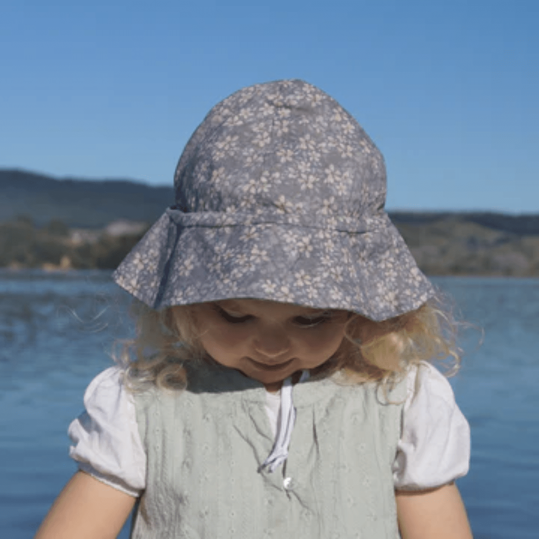 Girl-Wearing-Lola-And-Me-Linen-Sunhat-Floral-Violet-Naked-Baby-Eco-Boutique