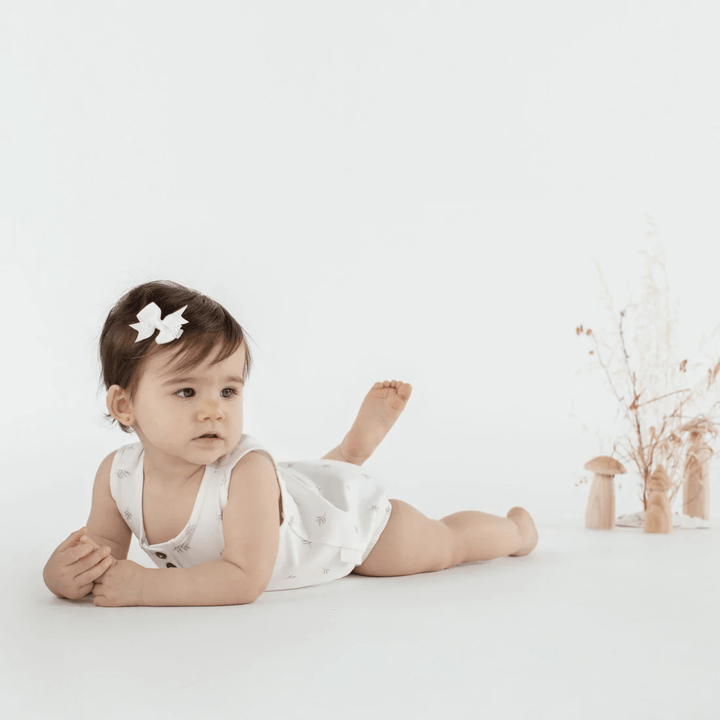 Happy-Girl-Wearing-Aster-And-Oak-Organic-Cotton-Little-Leaf-Bubble-Romper-Naked-Baby-Eco-Boutique
