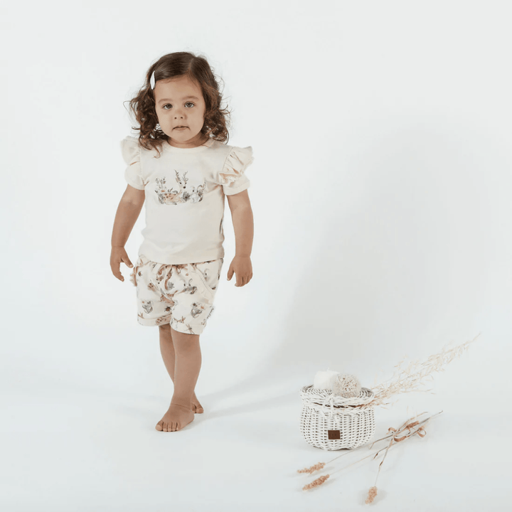 Happy-Girl-Wearing-Aster-And-Oak-Organic-Cotton-Ruffle-Shorts-Naked-Baby-Eco-Boutique
