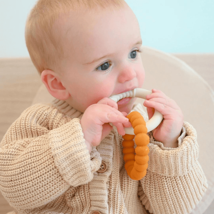 Jellystone-Designs-SIlicone-Sunshine-Teether-Baby-Chewing-On-Oat-And-Honey-Teether-Naked-Baby-Eco-Boutique