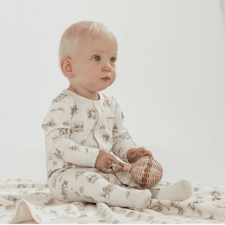 Little-Baby-Holding-Rattle-Wearing-Aster-And-Oak-Organic-Cotton-Baby-Pyjamas-Beaver-Naked-Baby-Eco-Boutique