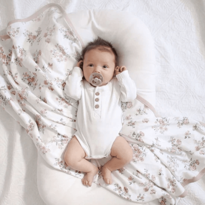 Little-Baby-Lying-On-Aster-And-Oak-Organic-Cotton-Baby-Swaddle-Wrap-Primrose-Naked-Baby-Eco-Boutique