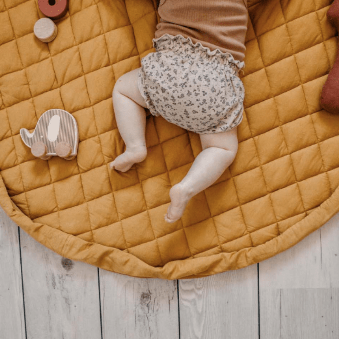 Little-Baby-Lying-On-Play-And-Go-Organic-Platmat-And-Storage-Bag-Mustard-Chai-Tea-Naked-Baby-Eco-Boutique