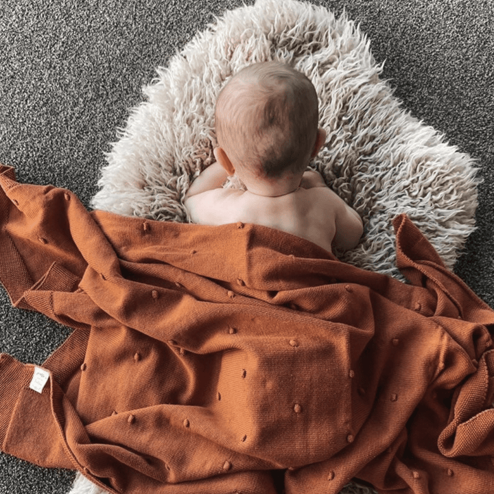 Little-Baby-On-Tummy-With-Over-The-Dandelions-Organic-Cotton-Billie-Blanket-Burnt-Amber-Naked-Baby-Eco-Boutique