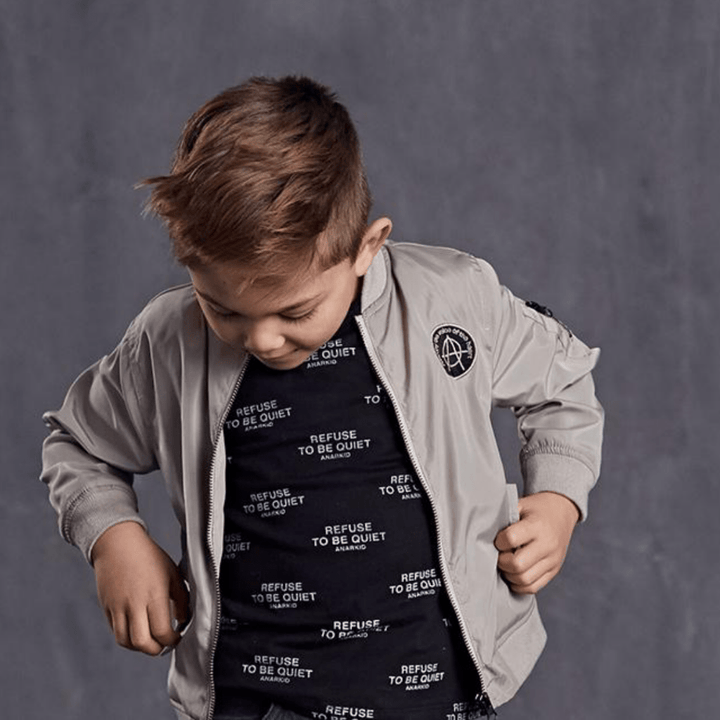 A young boy wearing an Anarkid Bomber Jacket (Multiple Variants).