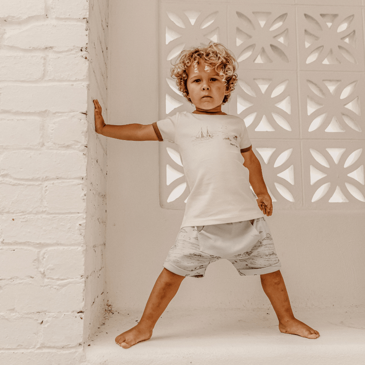 Little-Boy-Standing-with-Hand-on-Wall-Wearing-Aster-and-Oak-Organic-Ringer-Tee-Naked-Baby-Eco-Boutique