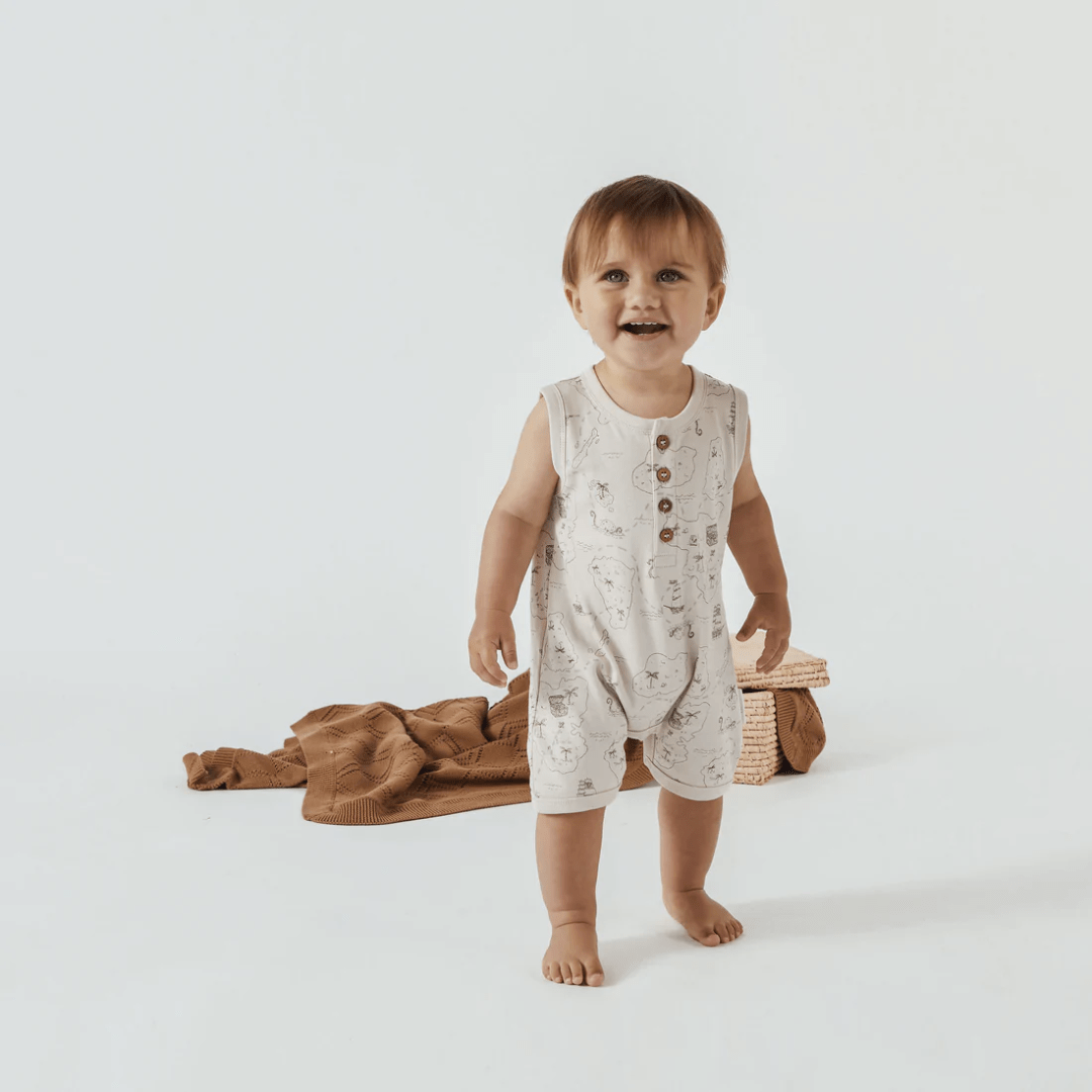 Little-Boy-Wearing-Aster-And-Oak-Organic-Cotton-Pirate-Map-Henley-Romper-Naked-Baby-Eco-Boutique