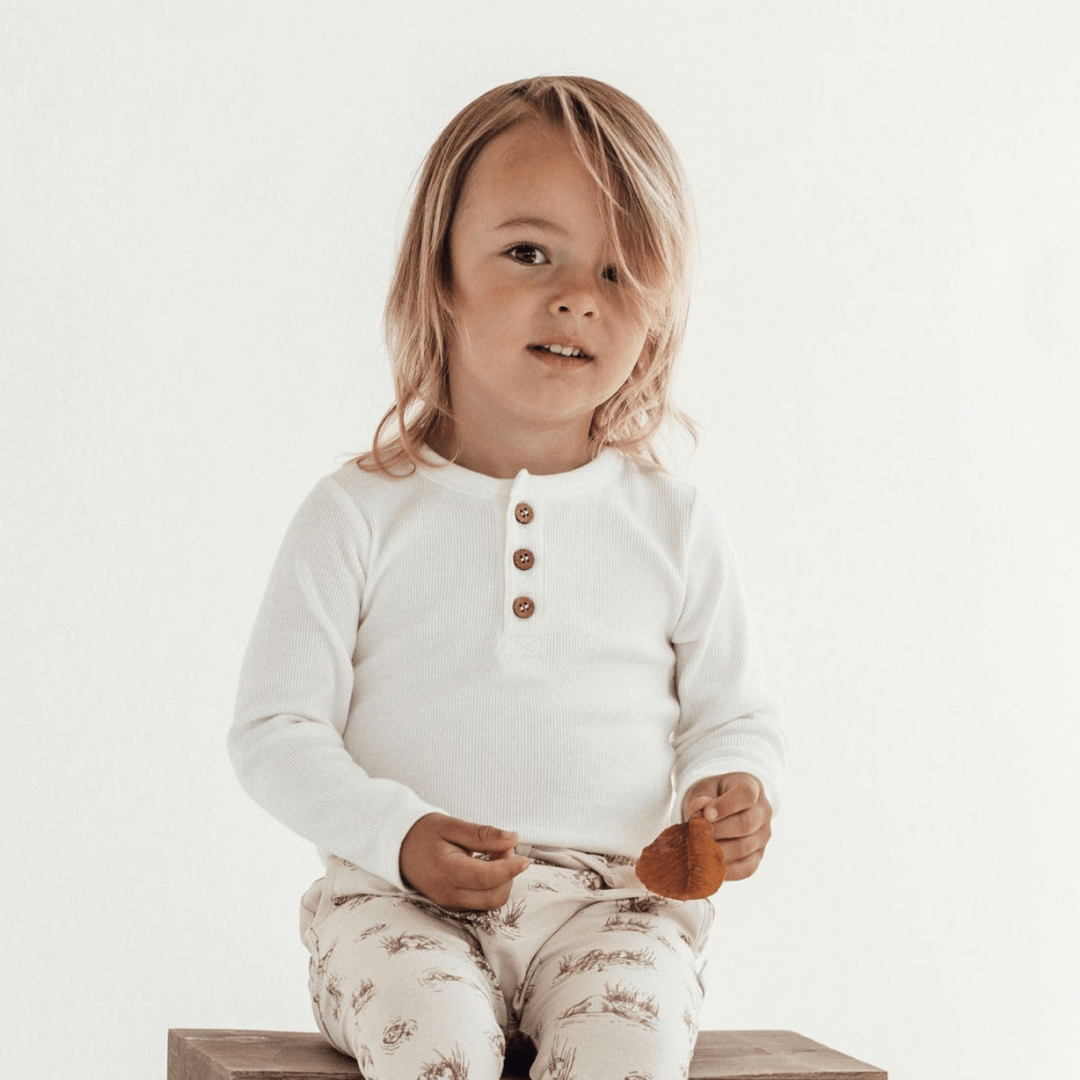 Little-Boy-Wearing-Aster-and-Oak-Organic-Rib-Henley-Top-Snow-with-Harem-Pants-Naked-Baby-Eco-Boutique