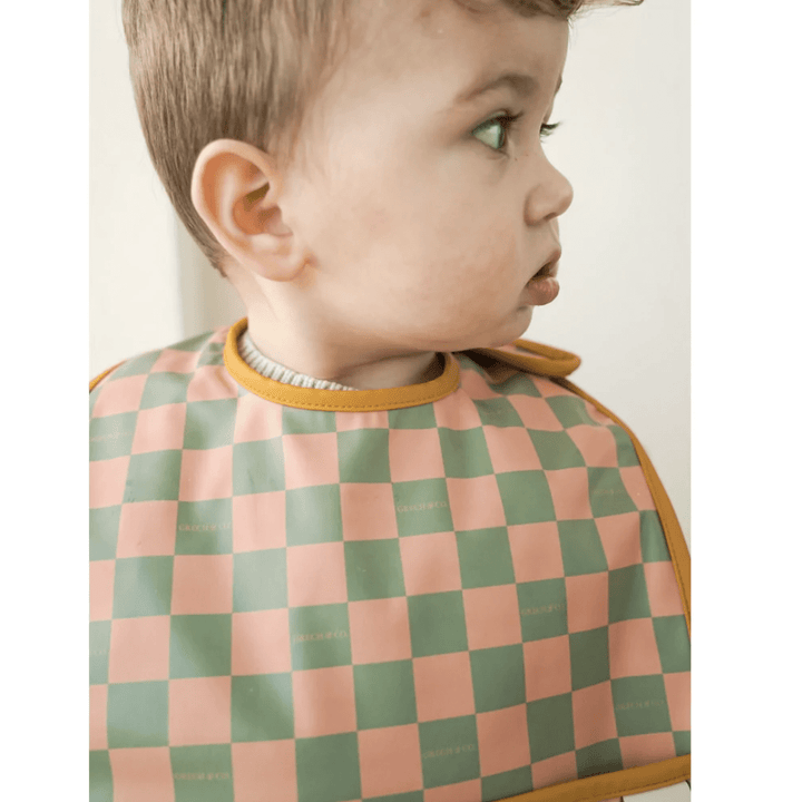 Little-Boy-Wearing-Grech-And-Co-Recycled-Smock-Bib-Checks-Sunset-And-Orchard-Naked-Baby-Eco-Boutique
