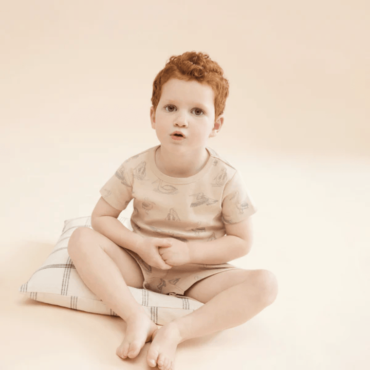 Little-Boy-Wearing-Wilson-And-Frenchy-Organic-Rib-Short-Sleeve-Pyjamas-Little-Pelican-Naked-Baby-Eco-Boutique
