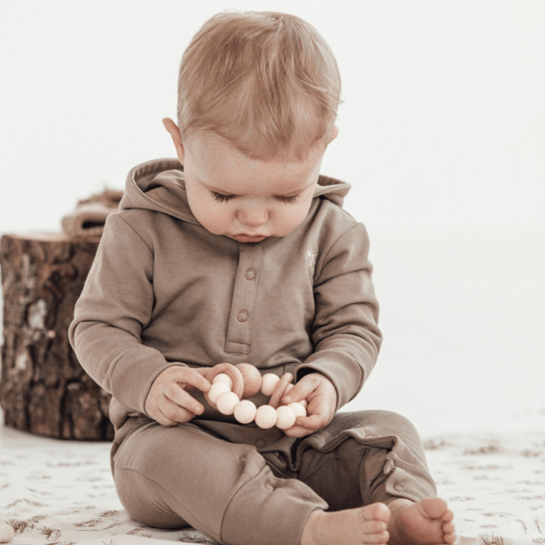 Little-Boy-With-Teether-Wearing-Aster-And-Oak-Organic-Cotton-Bear-Romper-Timber-Naked-Baby-Eco-Boutique