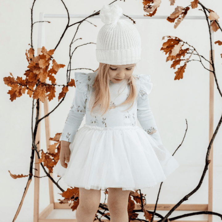 Little-Girl-Looking-Down-at-Skirt-Wearing-Aster-and-Oak-Organic-Tutu-Dress-Emmy-Floral-Naked-Baby-Eco-Boutique