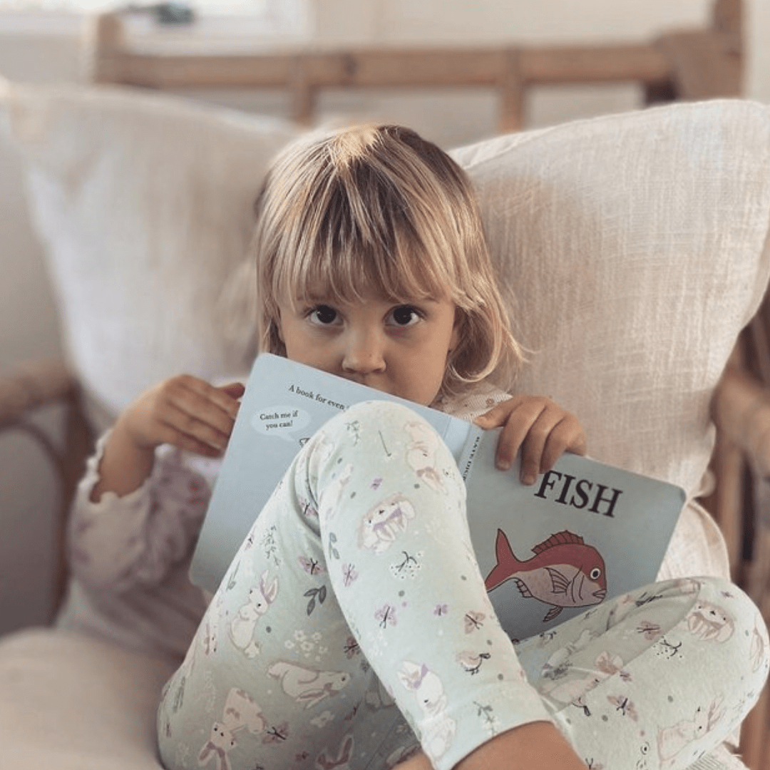 Little-Girl-Reading-Fish-Of-Aotearoa-Board-Book-Naked-Baby-Eco-Boutique