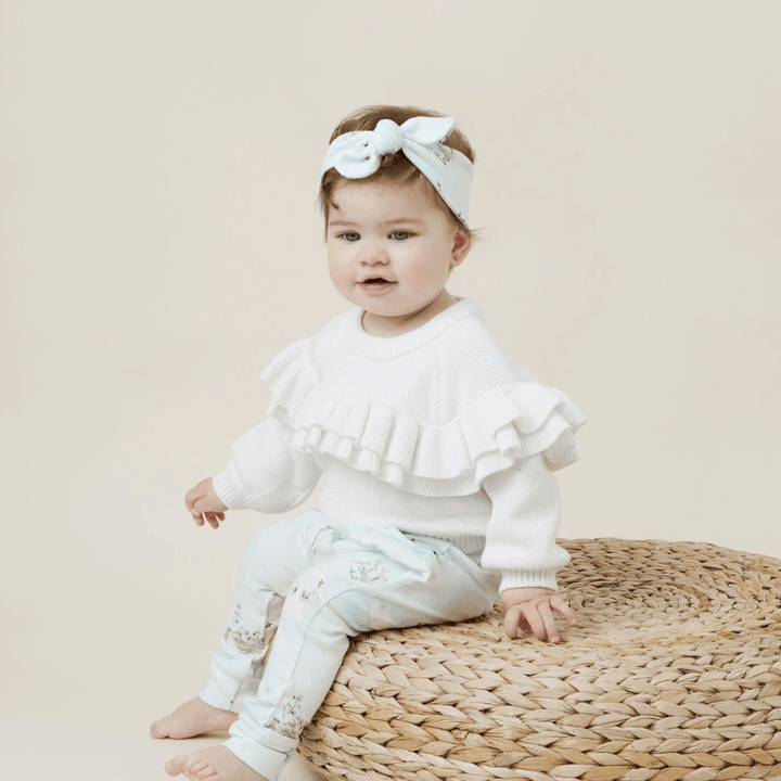 Little-Girl-Sitting-on-Stool-Wearing-Aster-and-Oak-Organic-Cotton-Headband-Swan-Naked-Baby-Eco-Boutique