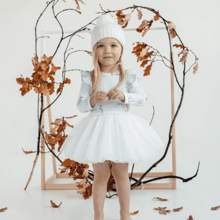 Little-Girl-Standing-in-Leaves-Wearing-Aster-and-Oak-Organic-Tutu-Dress-Swan-Naked-Baby-Eco-Boutique