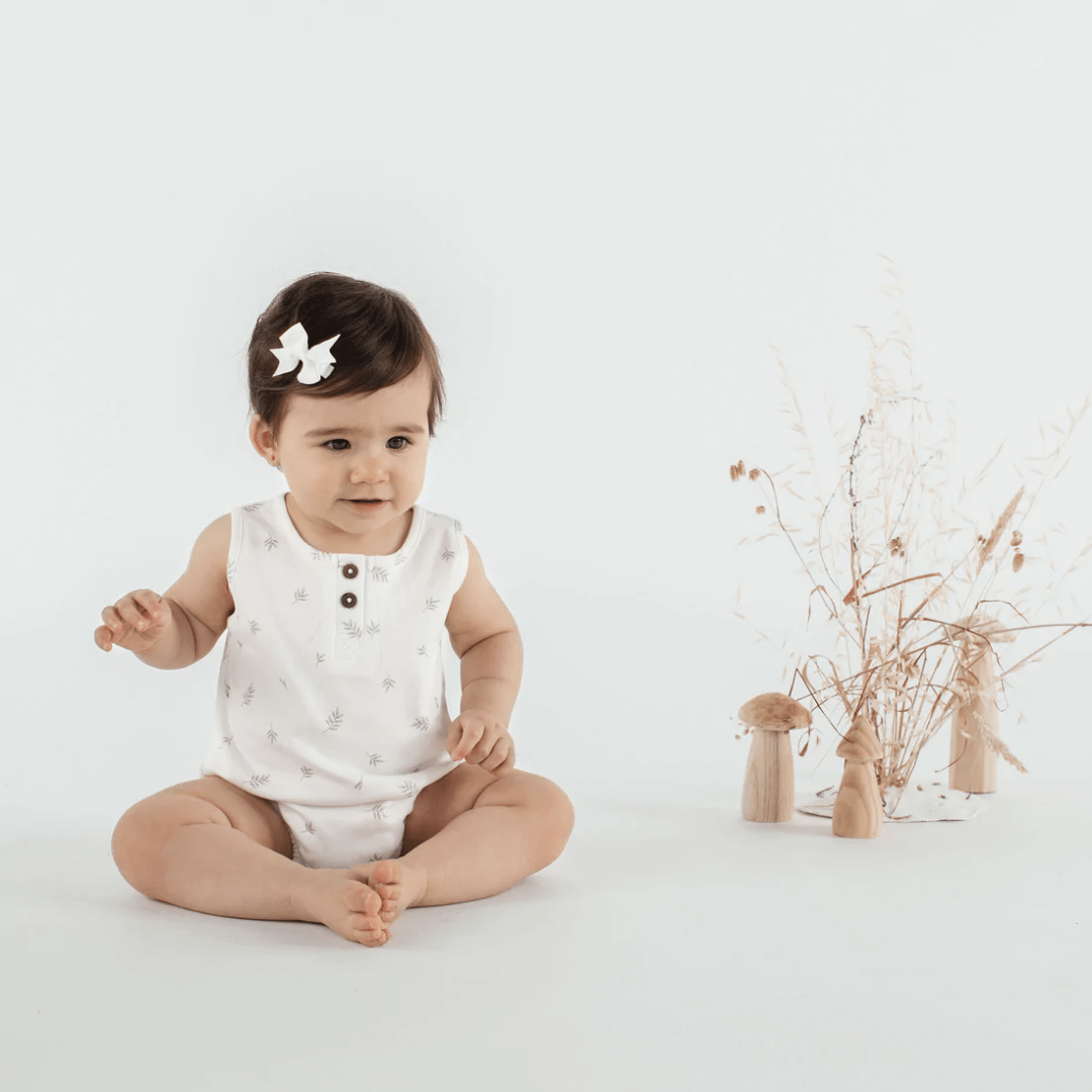 Little-Girl-Wearing-Aster-And-Oak-Organic-Cotton-Little-Leaf-Bubble-Romper-Naked-Baby-Eco-Boutique