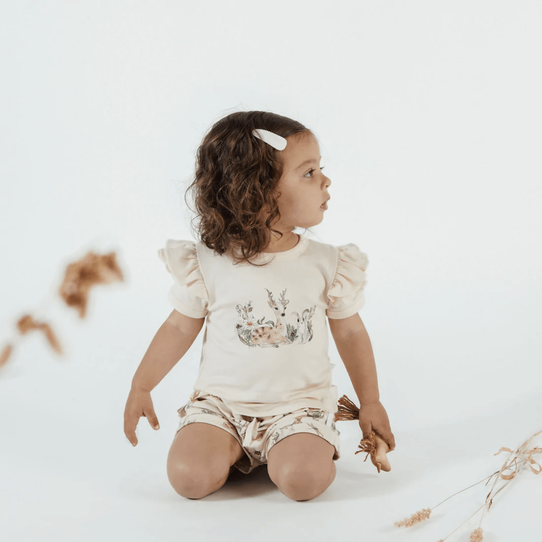 Little-Girl-Wearing-Aster-And-Oak-Organic-Cotton-Prairie-Print-Flutter-Tee-Naked-Baby-Eco-Boutique