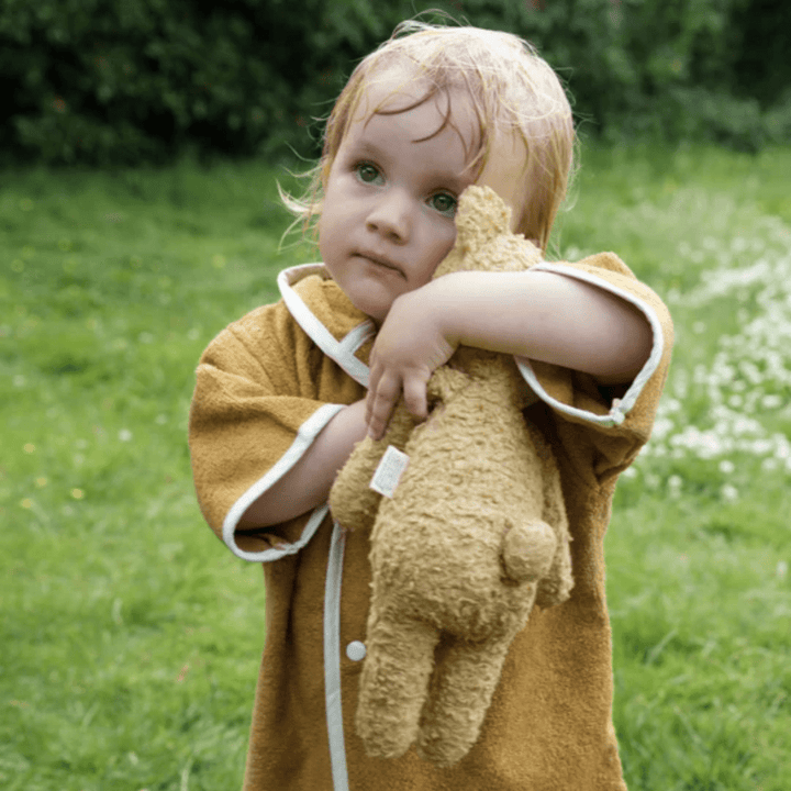 Little-Girl-Wearing-Fabelab-Organic-Cotton-Baby-Poncho-Robe-Ochre-Bear-Naked-Baby-Eco-Boutique