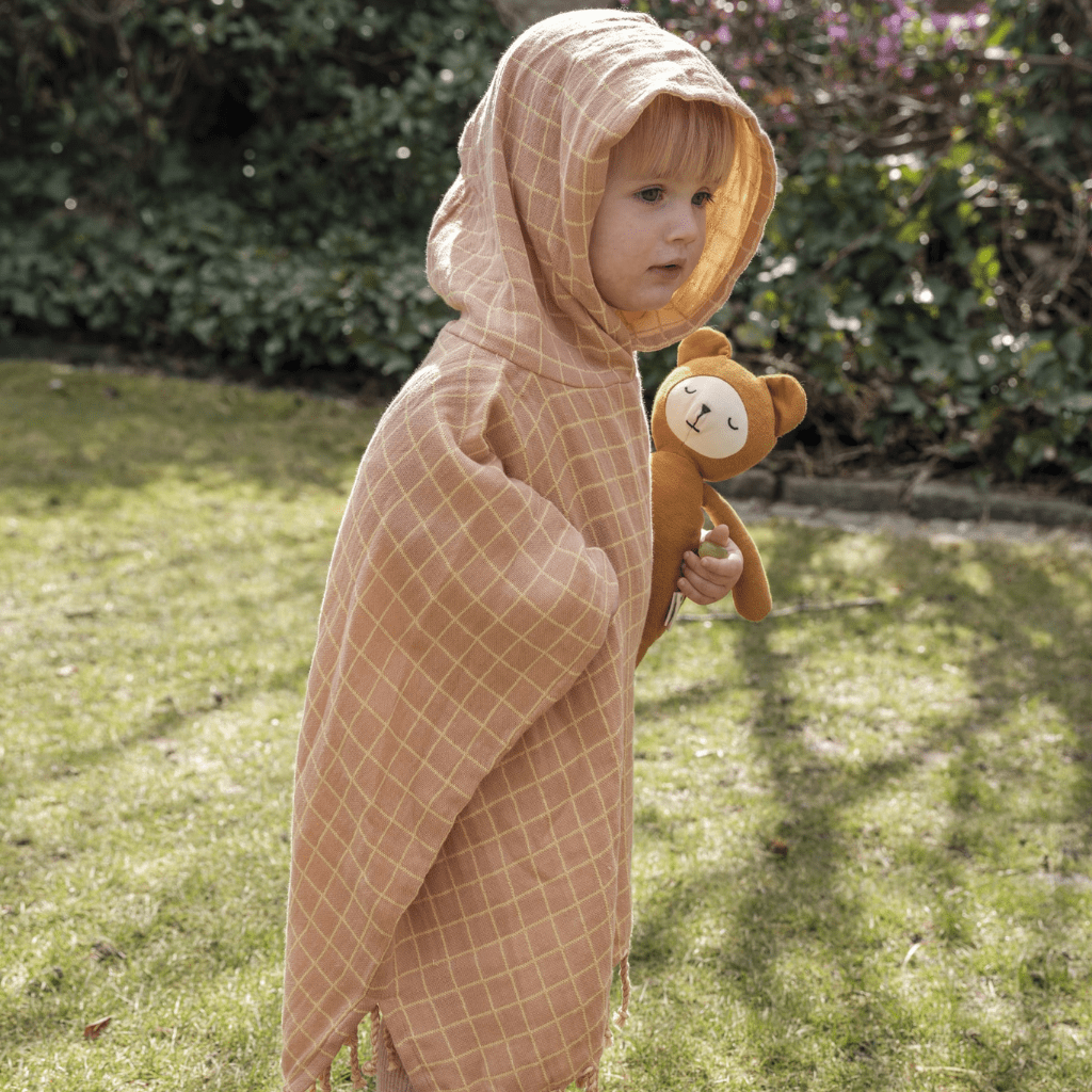 Little-Girl-Wearing-Fabelab-Organic-Cotton-Grid-Kids-Poncho-Old-Rose-Naked-Baby-Eco-Boutique