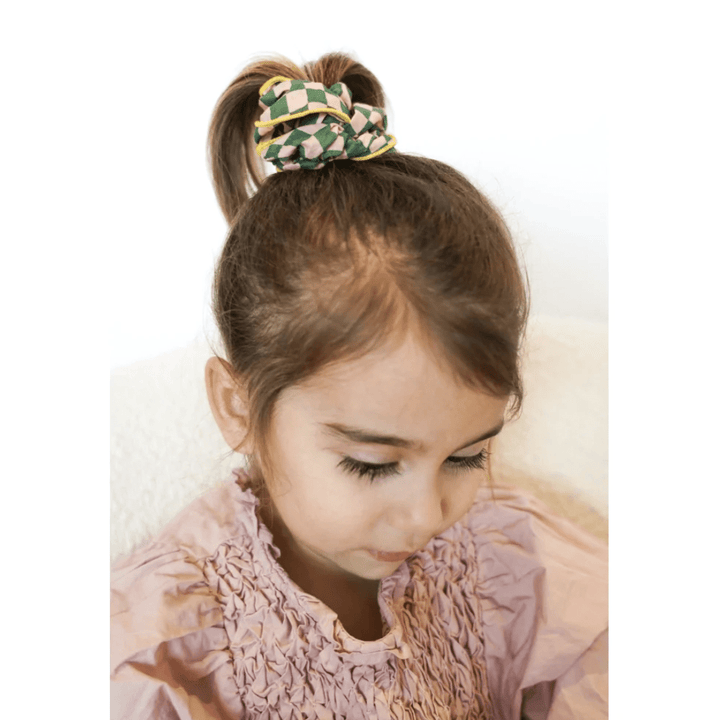 Little-Girl-Wearing-Grech-And-Co-Organic-Cotton-Hair-Scrunchies-Two-Pack-Checks-Laguna-And-Wheat-Naked-Baby-Eco-Boutique