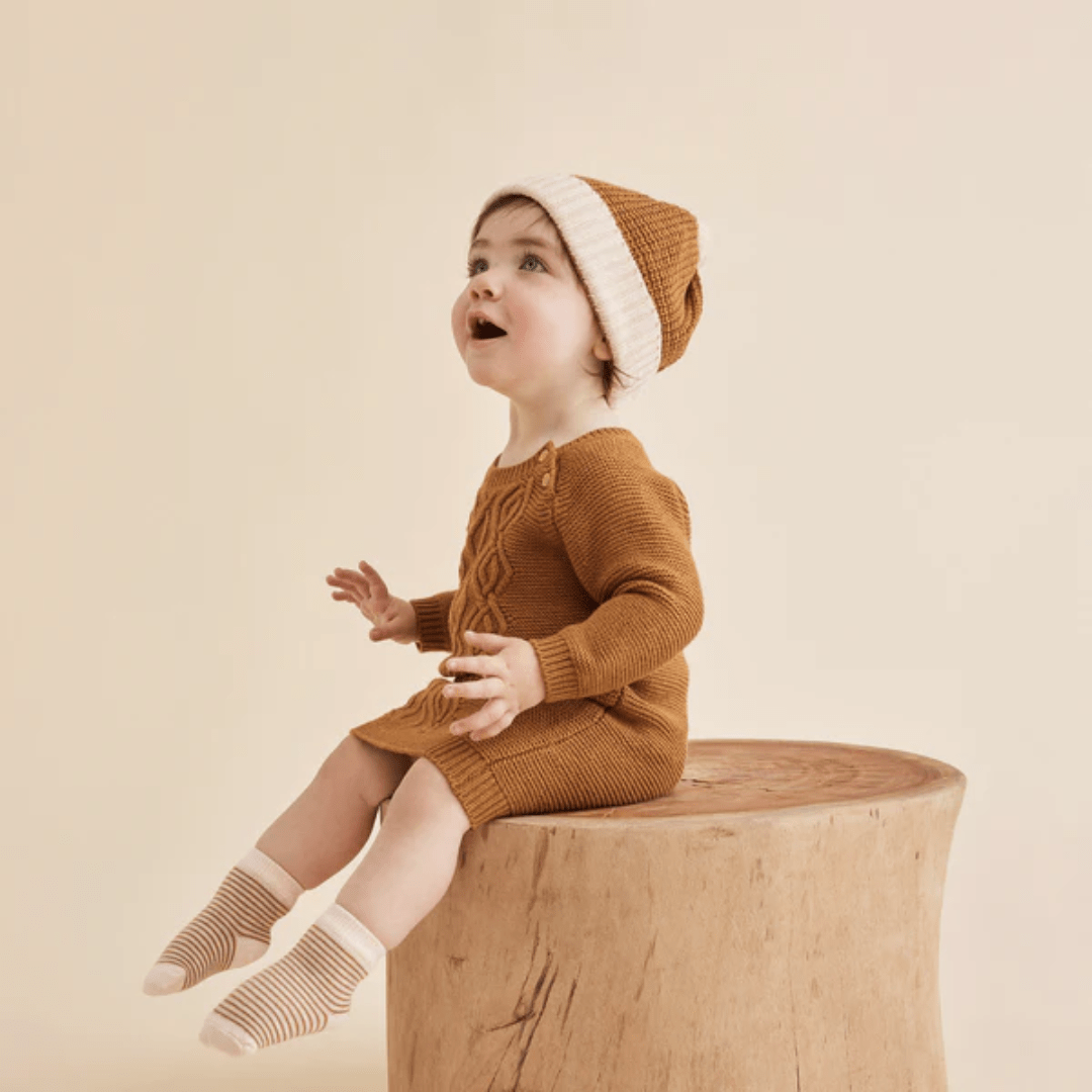 Little-Girl-Wearing-Wilson-And-Frenchy-Knitted-Cable-Dress-Spice-Naked-Baby-Eco-Boutique