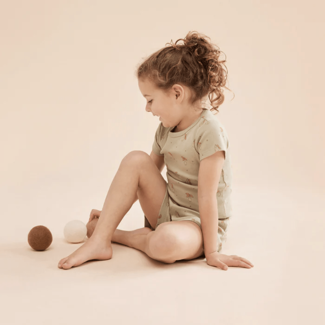 Little-Girl-Wearing-Wilson-And-Frenchy-Organic-Rib-Short-Sleeve-Pyjamas-Perfect-Pears-Naked-Baby-Eco-Boutique
