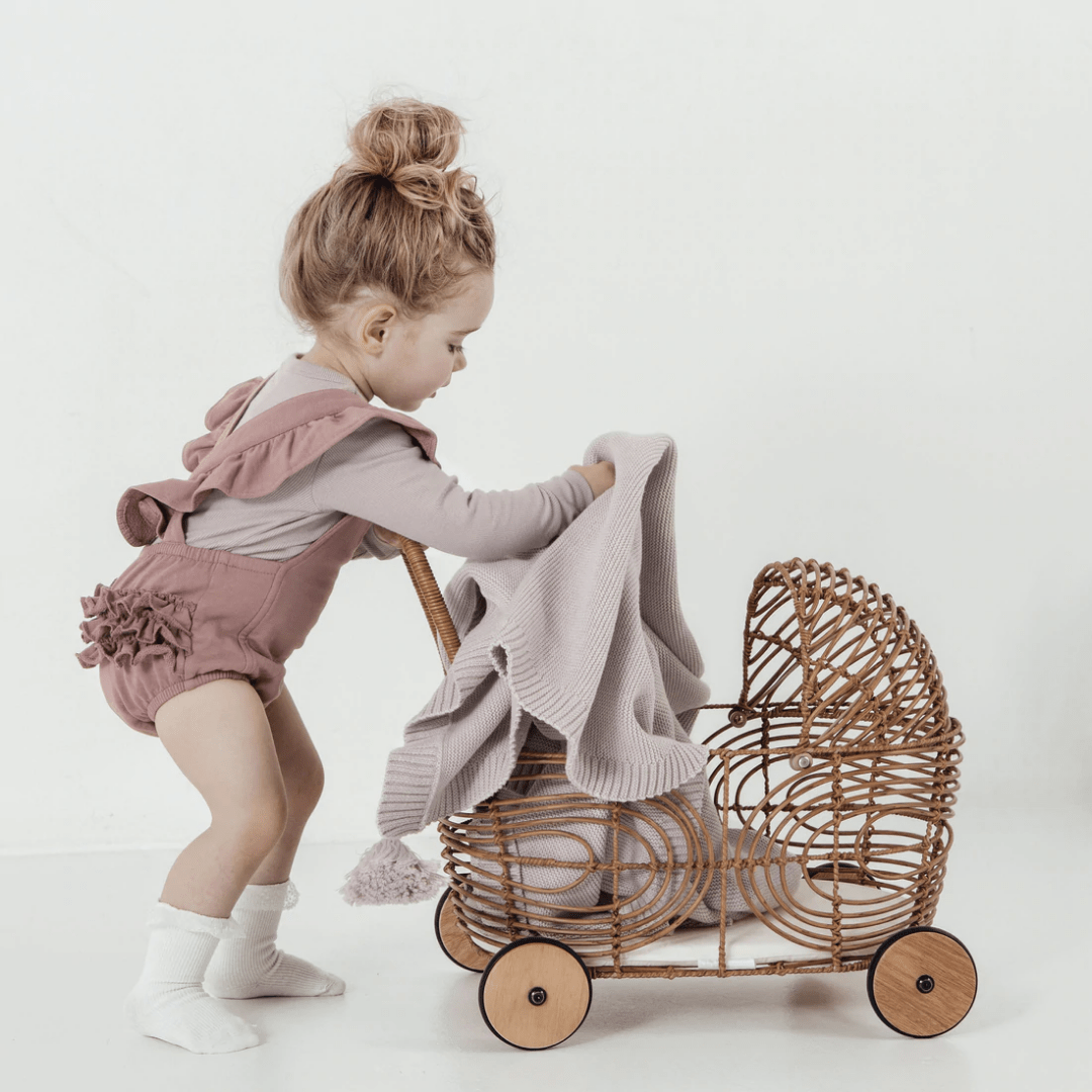 Little-Girl-With-Pram-Using-Aster-And-Oak-Cotton-Chunky-Knit-Blanket-Violet-Naked-Baby-Eco-Boutique