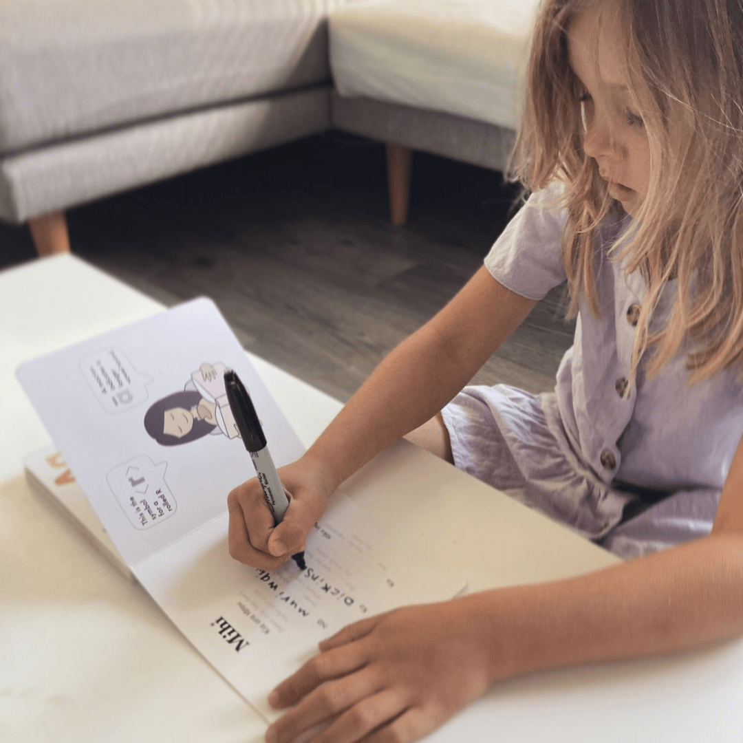 Little-Girl-Writing-In-Te-Reo-Maori-For-Preschoolers-Board-Book-Naked-Baby-Eco-Boutique