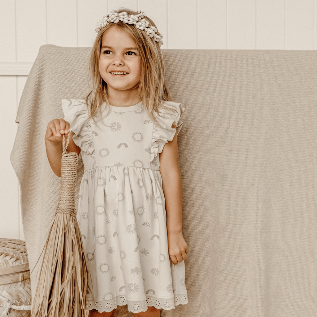 Little-Girl-with-Flower-Crown-Wearing-Aster-and-Oak-Sunny-Daze-Ruffle-Dress-Naked-Baby-Eco-Boutique