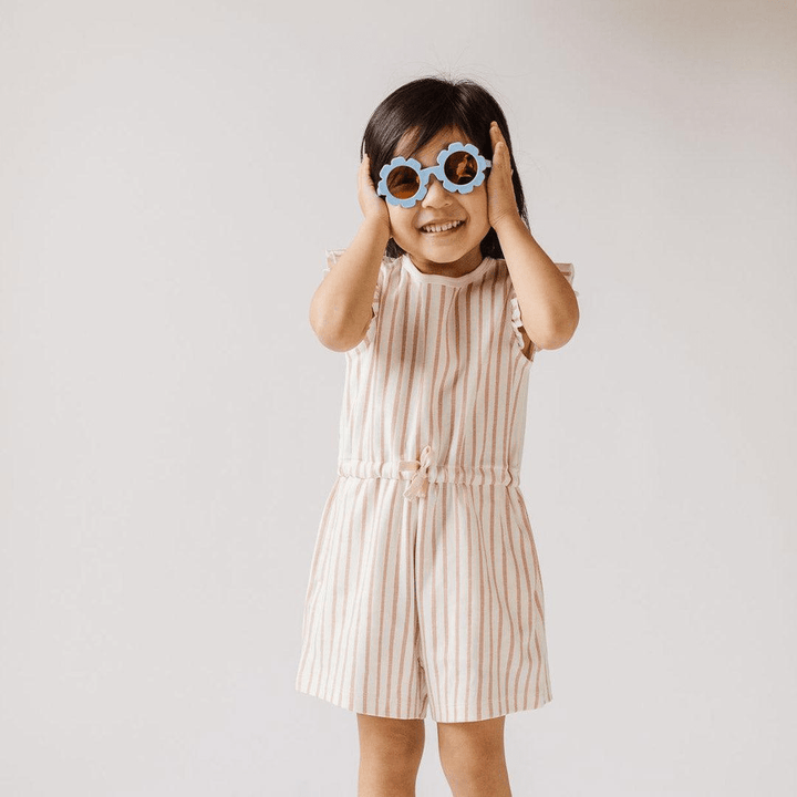 Little-Girl-with-Hands-on-Head-Wearing-Babiators-Flower-Polarized-Baby-Kids-Sunglasses-The-Wildflower-Naked-Baby-Eco-Boutique