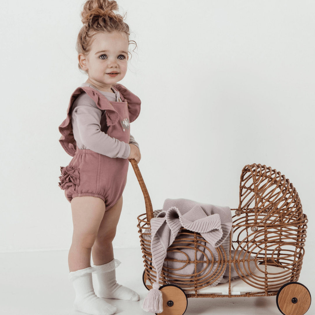 Little-Girl-with-Toy-Pram-Wearing-Aster-and-Oak-Organic-Rib-Henley-Top-Violet-Naked-Baby-Eco-Boutique
