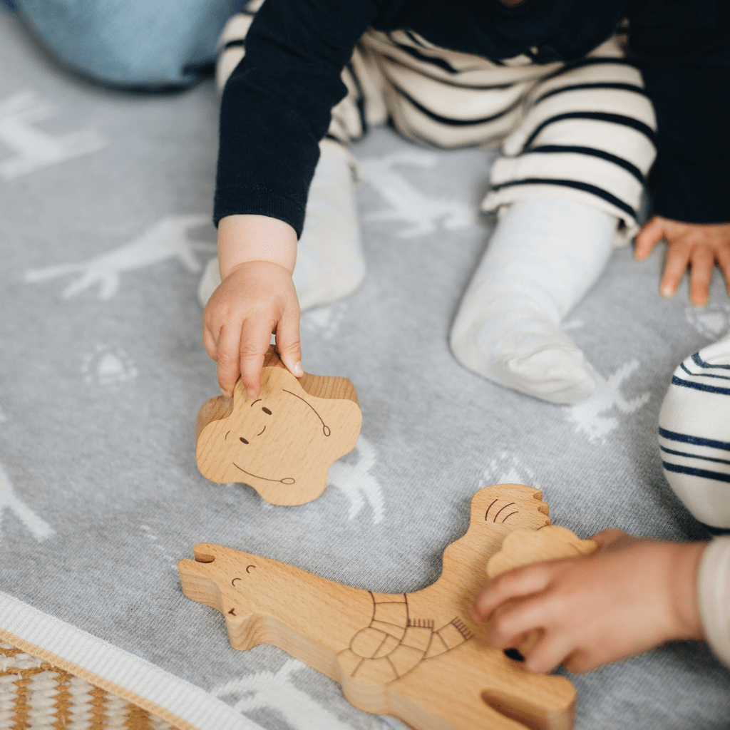 Little-Hands-Playing-with-The-Kiss-Co-Apiti-3-Piece-Wooden-Puzzle-Naked-Baby-Eco-Boutique
