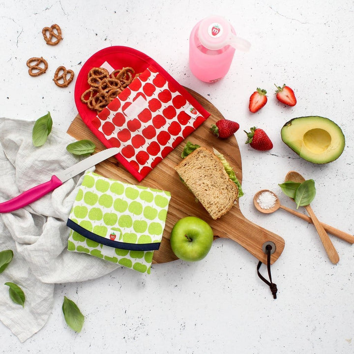 A Munch Organic Reusable Lunch Wrap - LUCKY LAST - GREEN APPLE with a sandwich, fruit, pretzels and pretzel sticks.