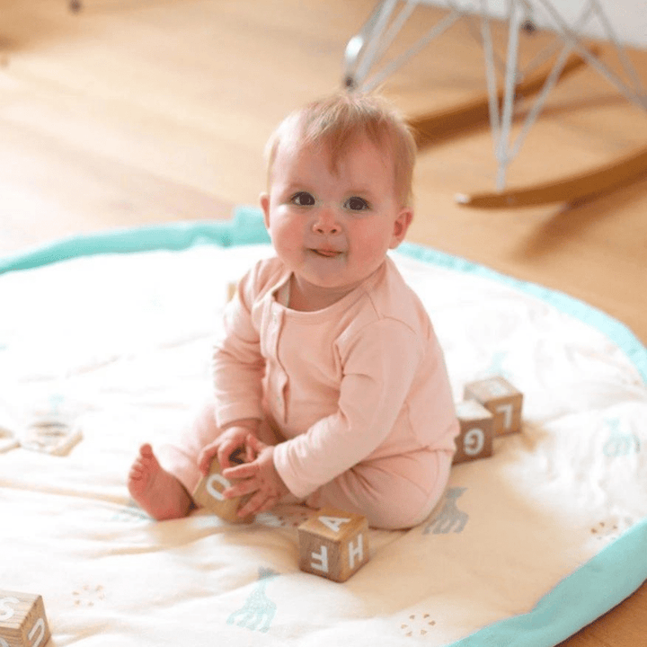    Play-And-Go-Soft-Toy-Storage-Bag-And-Playmat-Giraffe-Baby-Girl-Sitting-On-Mat-Naked-Baby-Eco-Boutique.