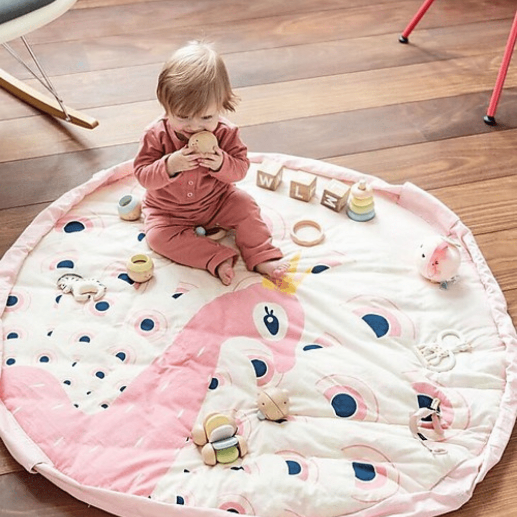    Play-And-Go-Soft-Toy-Storage-Bag-And-Playmat-Peacock-Little-Girl-Playing-On-Mat-Naked-Baby-Eco-Boutique.