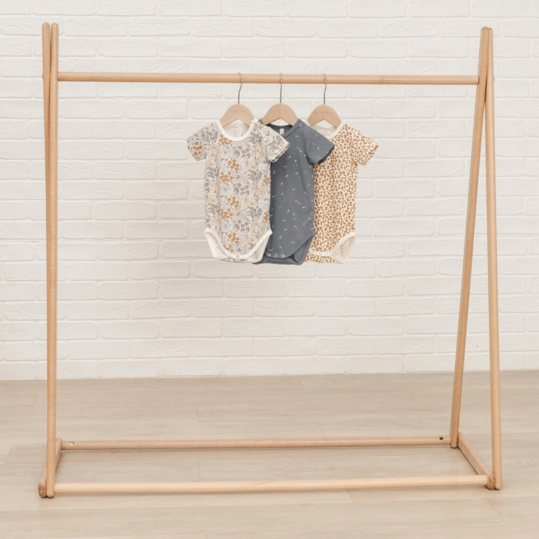 Quincy-Mae-Bamboo-Onesie-Hanging-on-Rack-Naked-Baby-Eco-Boutique