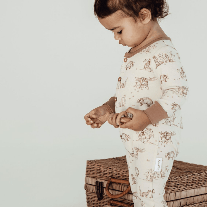 Side-View-of-Child-Wearing-Aster-and-Oak-Organic-Cotton-Button-Romper-Badger-Naked-Baby-Eco-Boutique